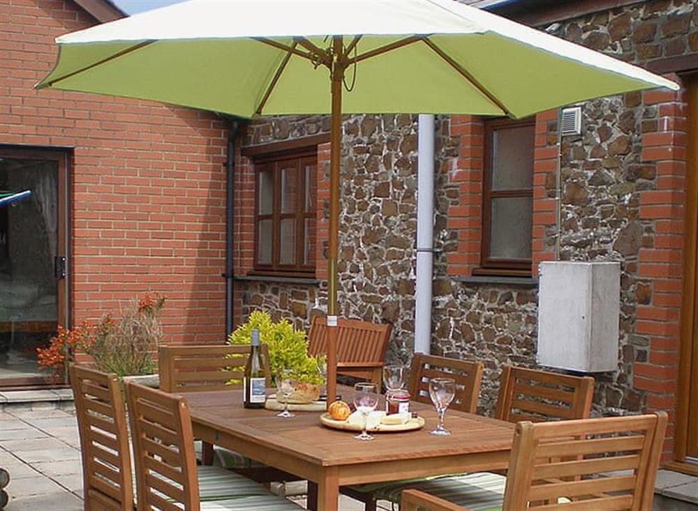 Secluded patio with outdoor eating area at The Round House in Pyworthy, near Holsworthy, Devon