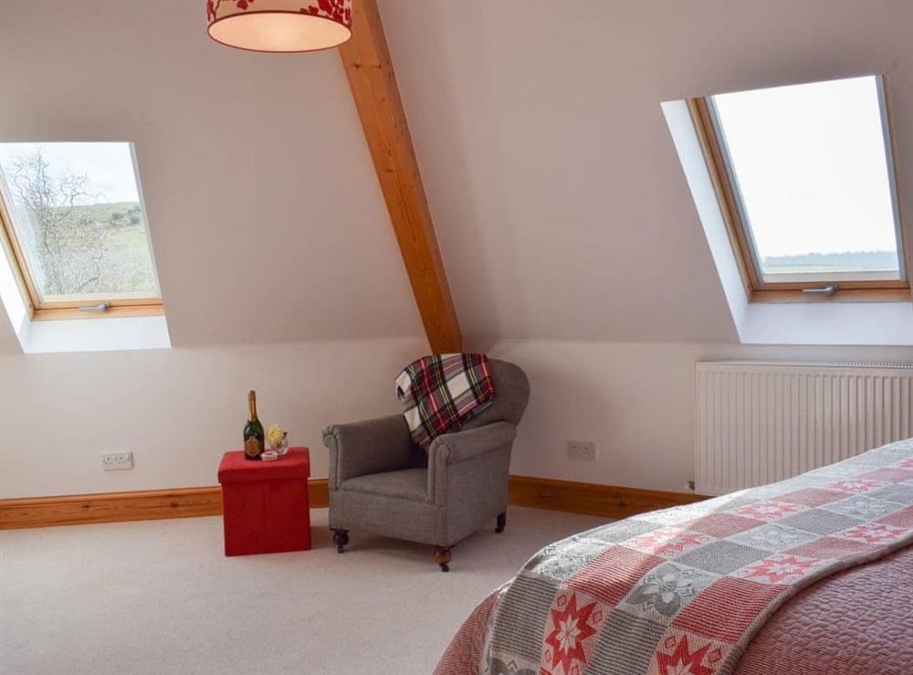 Bedroom with sloping ceiling and exposed woodwork at The Roundel in Balmullo, near St Andrews, Fife