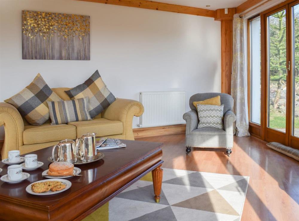 Comfortable living area with doors to the garden at The Roundel in Balmullo, near St Andrews, Fife
