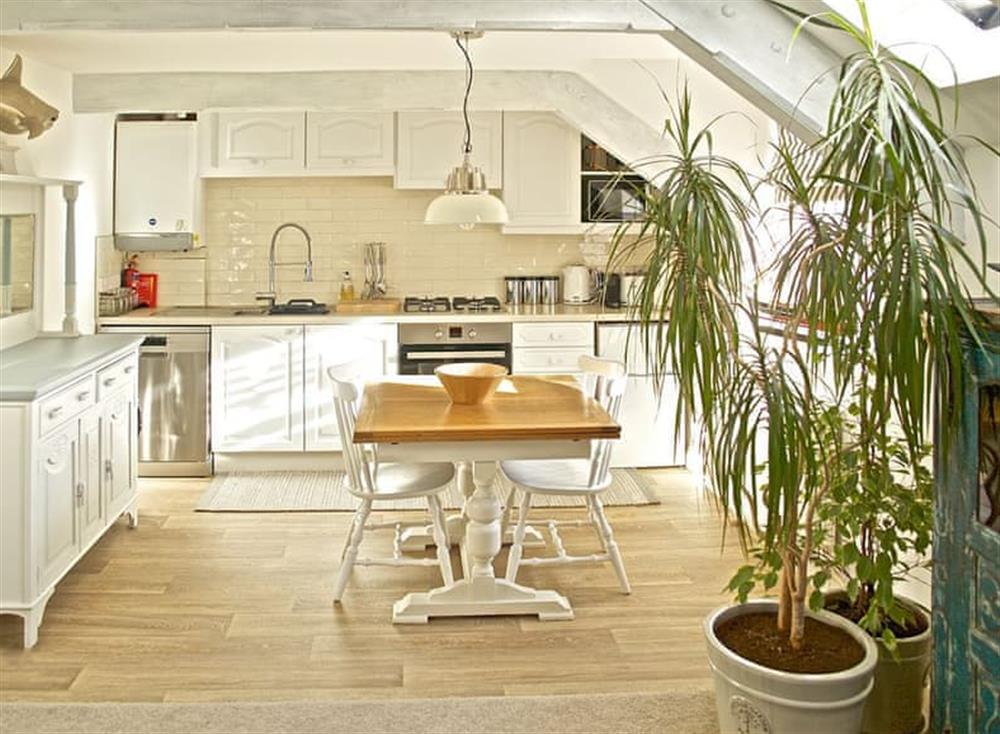 Fully equipped kitchen with dining area at The Salt Loft in Fowey, Cornwall