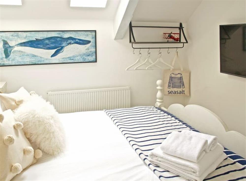 The stylish bedroom boasts a king-size bed and a Smart TV at The Salt Loft in Fowey, Cornwall