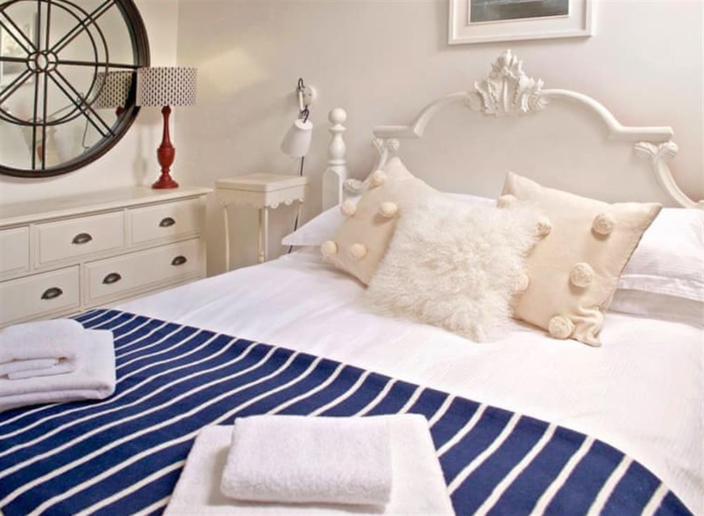 The stylish bedroom boasts a king-size bed at The Salt Loft in Fowey, Cornwall