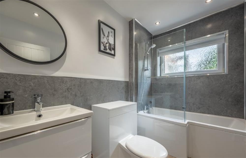 Ground floor: The bathroom has a bath with shower over at The Saltings, Heacham near Kings Lynn