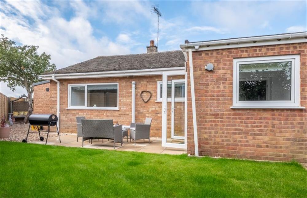 Ground floor: The garden is laid to lawn with paved patio area at The Saltings, Heacham near Kings Lynn