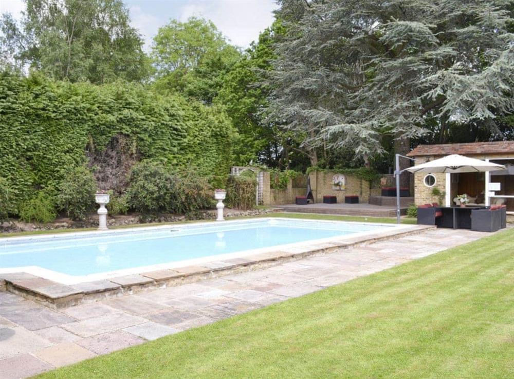 Outdoor swimming pool and summer house at The Sanctuary in Little Chart, near Ashford, Kent