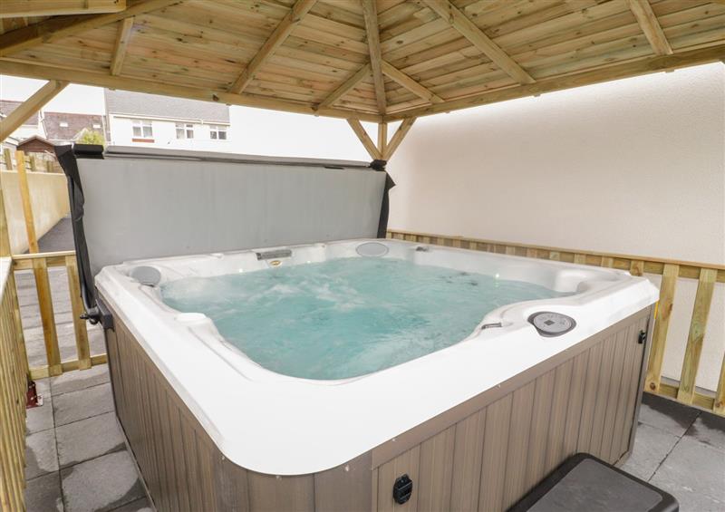 Relax in the hot tub at The Sandy Bee, Benllech