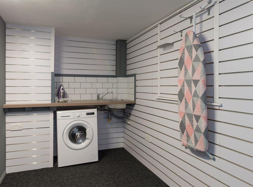 Laundry room and secure bike storage, accessed via the courtyard
