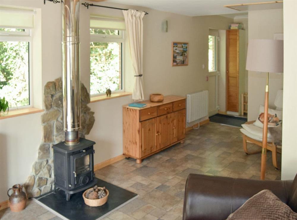 Cosy open plan living space with wood burner at The Shippon in Pyworthy, near Bude, Devon