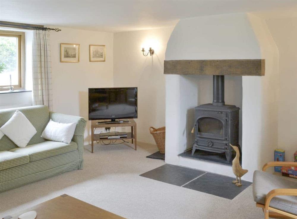 Welcoming living room with wood burner at The Shippon in St Gennys, Bude, N. Cornwall., Great Britain