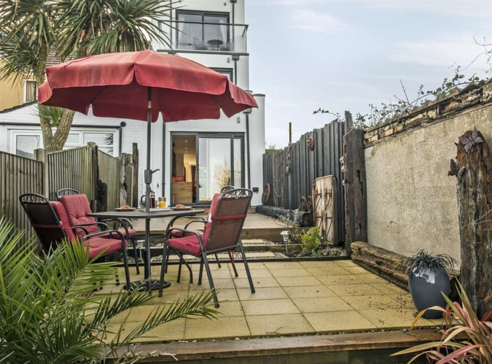 Enclosed garden with patio and garden furniture at The Shipwreck in Oulton Broad, near Lowestoft, Suffolk