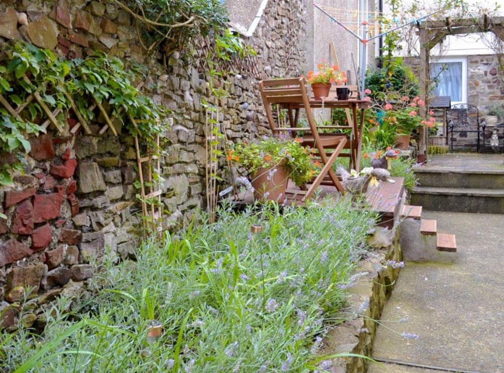 The courtyard style garden is a relaxing outdoor space with solar lighting and decking complete with garden furniture at The Shoe Box in Northam, near Bideford, Devon