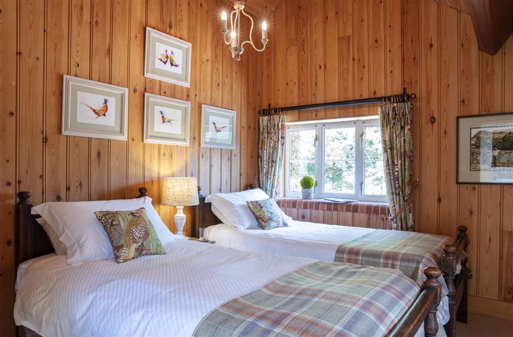 Bedroom four; The Honeysuckle Room, located on the first floor, with twin 3’ single beds at The Shooting Lodge, Dorset