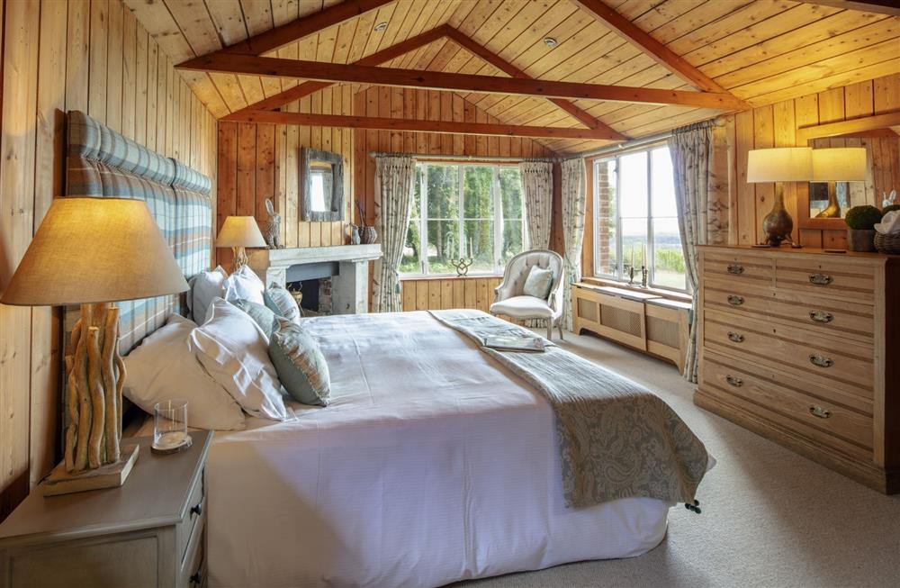 Bedroom two; The Beaters Bedroom on the ground floor with 6’ super-king zip and link bed at The Shooting Lodge, Dorset