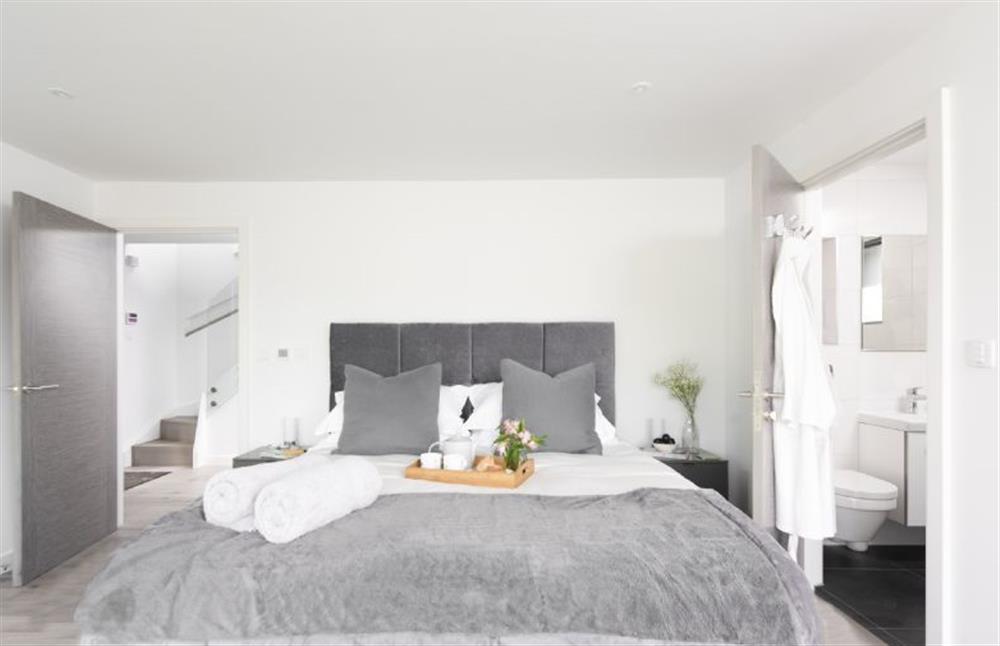 Bedroom one on the ground floor with en-suite shower room at The Shore, Mawgan Porth