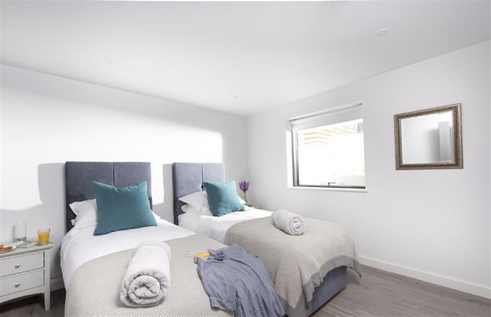 Bedroom two on the ground floor with twin 3’ single beds at The Shore, Mawgan Porth
