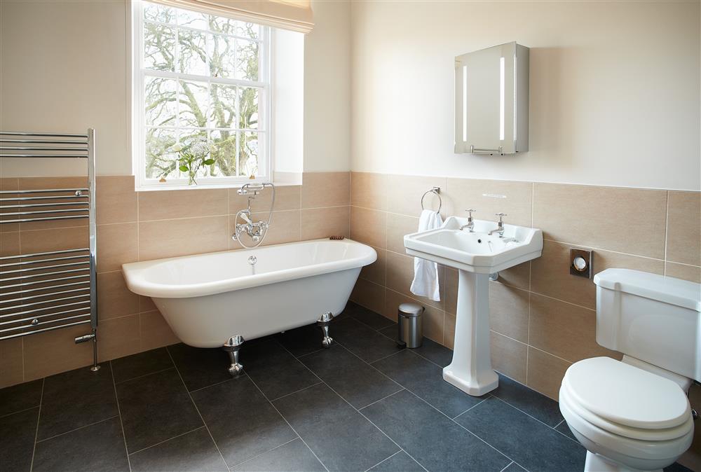 En-suite bathroom with roll top bath and separate walk-in shower at The Sir Walter Scott Apartment, Netherby Hall, Longtown