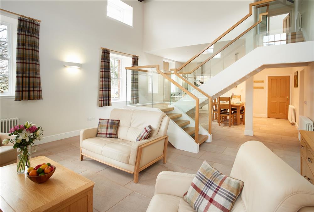 Open-plan living area leading through to the kitchen and dining area at The Sir Walter Scott Apartment, Netherby Hall, Longtown