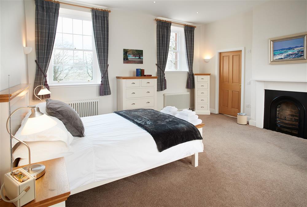 Spacious bedroom with a 5’ king-size bed and en-suite bathroom at The Sir Walter Scott Apartment, Netherby Hall, Longtown