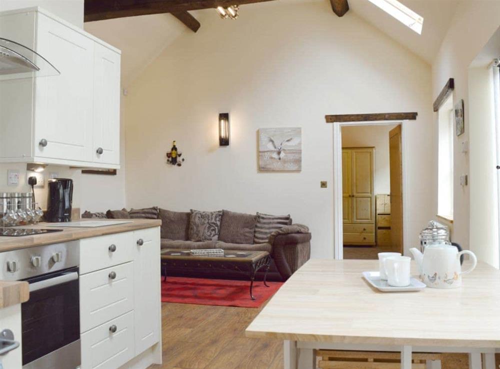Open plan living/dining room/kitchen with beams throughout at The Smithy in Little Witley, Worcestershire, England