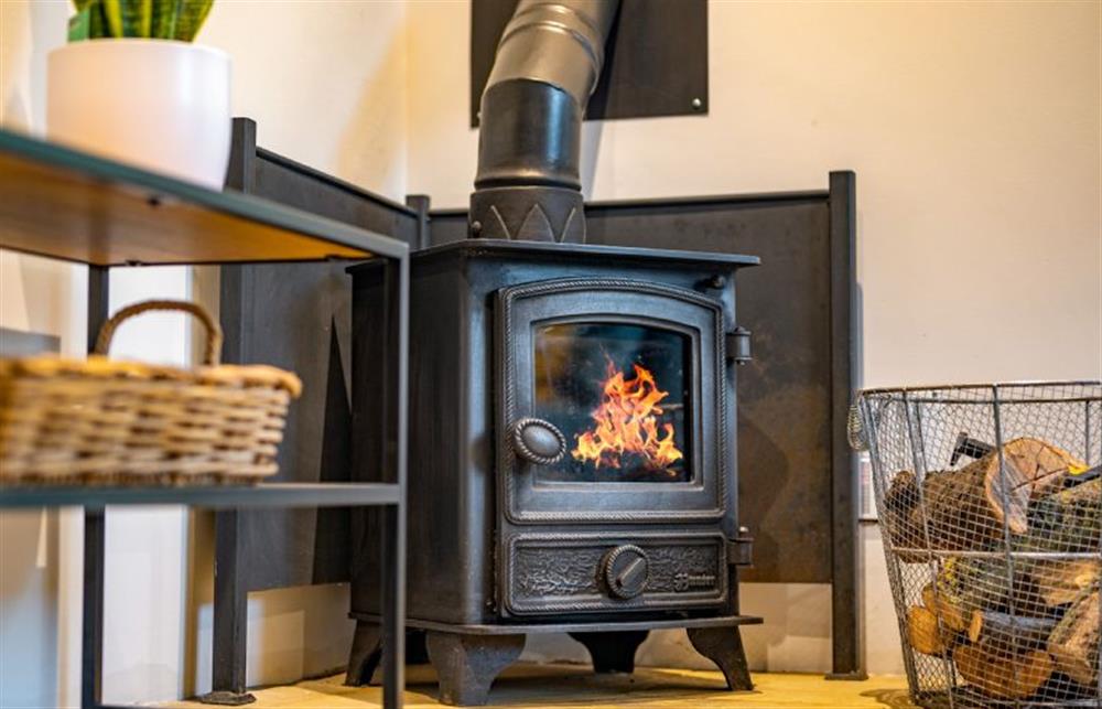 Ground floor: Sitting room with cosy wood burning stove at The Smokehouse, Ingoldisthorpe near Kings Lynn