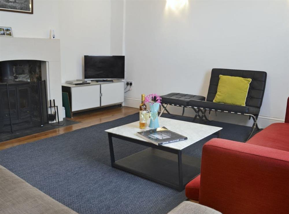 Spacious living room with cosy woodburner at The Square in Hartland, near Bideford, Devon