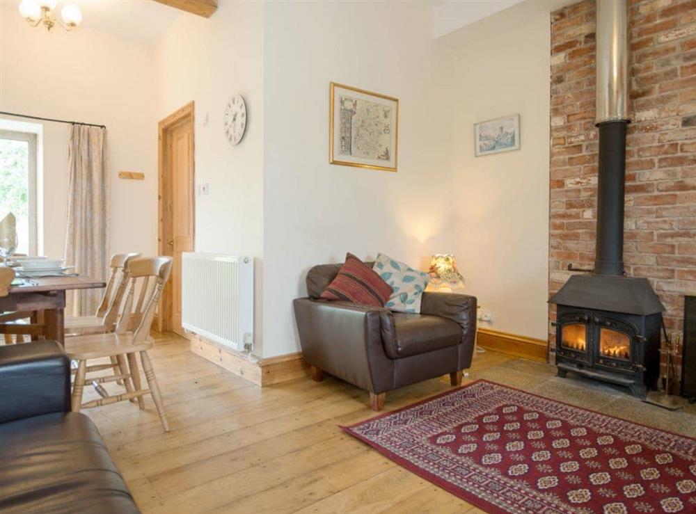 Warm and inviting living room with wood burner at The Stable in Foxham, near Chippenham, Wiltshire