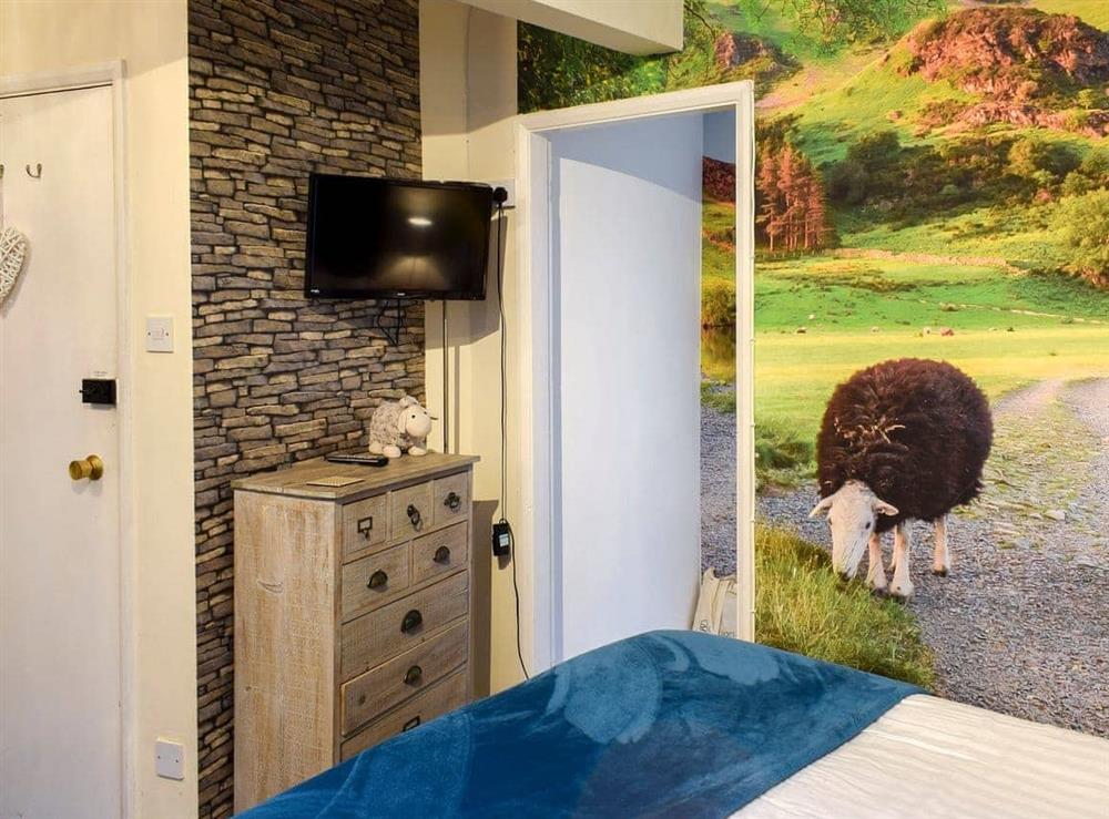 Bedroom area with double bed at The Stable Nest in Bowness on Windermere, Cumbria