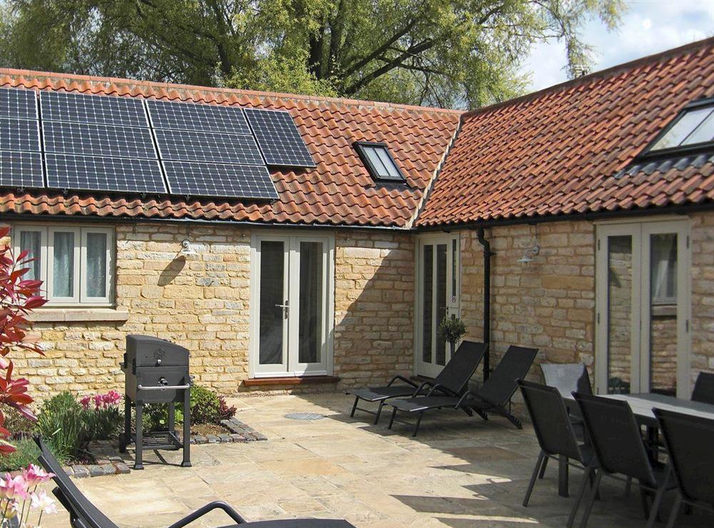 Secluded, enclosed courtyard with patio at The Stables in Aisby, near Grantham, Lincolnshire, England