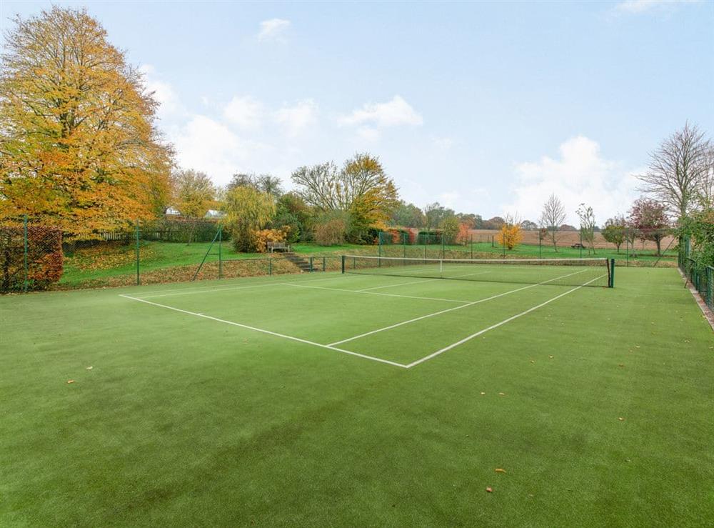 Tennis court at The Stables at Wells-in-the-Field Farm in Wells-in-the-Field, near Whitchurch, Hampshire