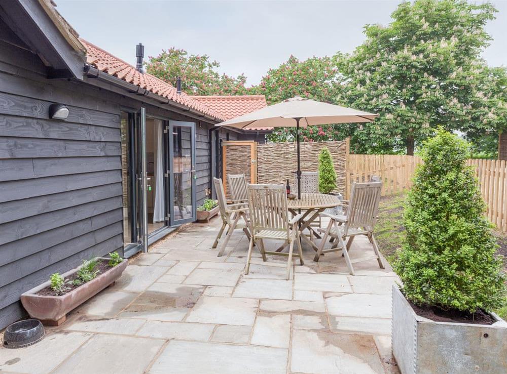 Large patio area with outdoor furniture at The Stables in Beauworth, near Alresford, Hampshire