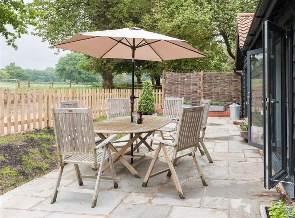 Paved patio area with rural views at The Stables in Beauworth, near Alresford, Hampshire