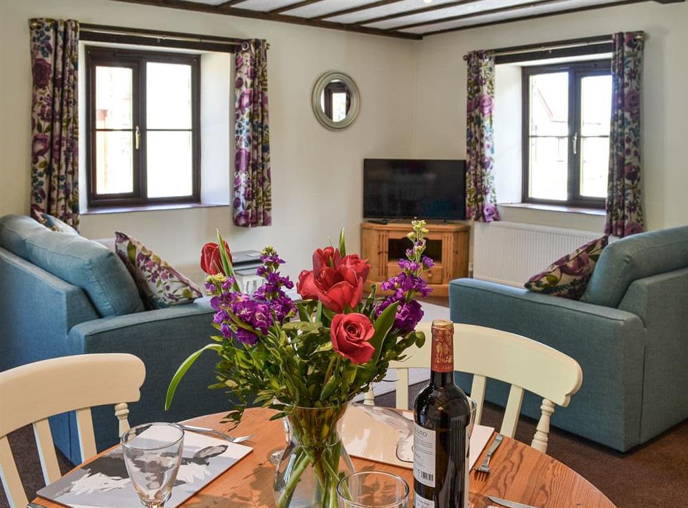 Living room with dining area at The Stables in Buckland Brewer, near Bideford, Devon