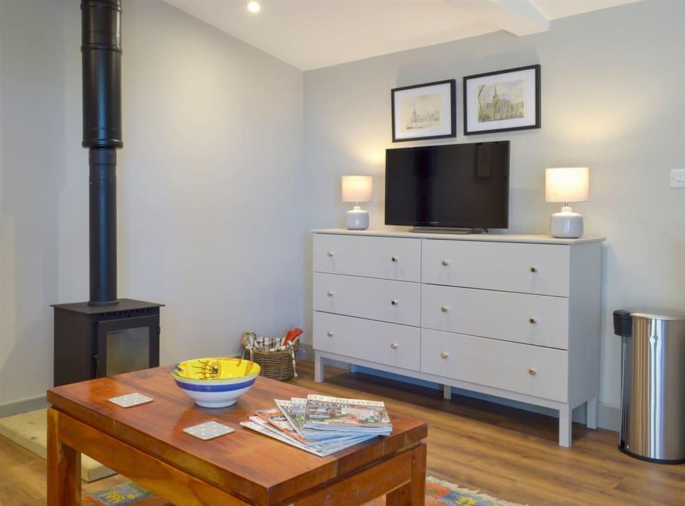Cosy living area with wood burner at The Haybarn, 