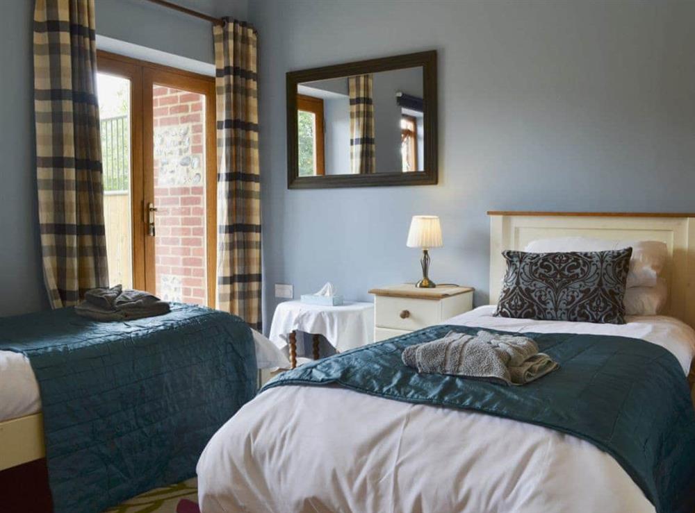 Twin bedroom with French doors at The Stables in Martin, Fordingbridge, Hants., Hampshire