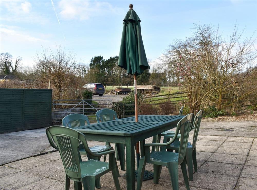 Small patio area with garden furniture (photo 2) at The Stables, Mill Farm in Okeford Fitzpaine, Dorset
