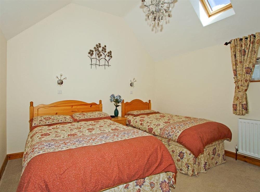 Spacious family bedroom with one double and one single bed at The Stables in North Somercotes, near Louth, Lincolnshire