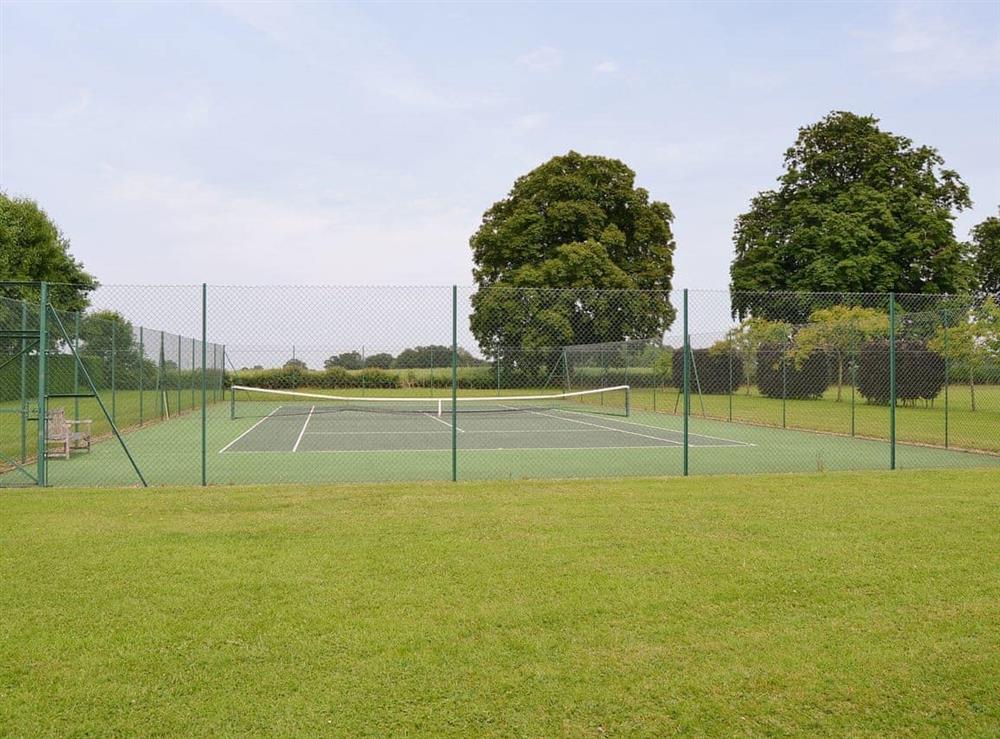 Full-size tennis court at The Stables in Occold, Nr Eye, Suffolk., Great Britain