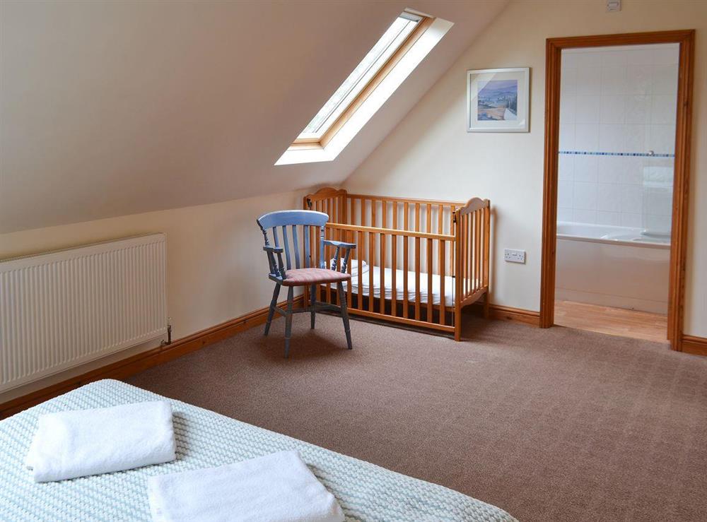 Double bedroom with child’s cot at The Stables in Somersal Herbert, near Ashbourne, Derbyshire