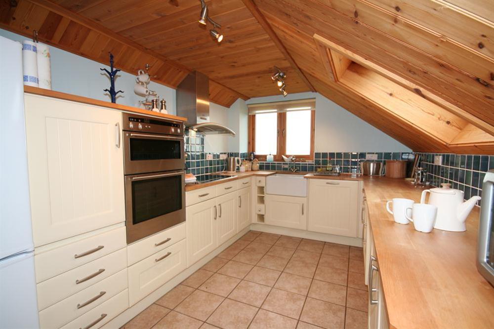 Well-equipped kitchen built into the roof space at The Station in Malborough, Nr Kingsbridge