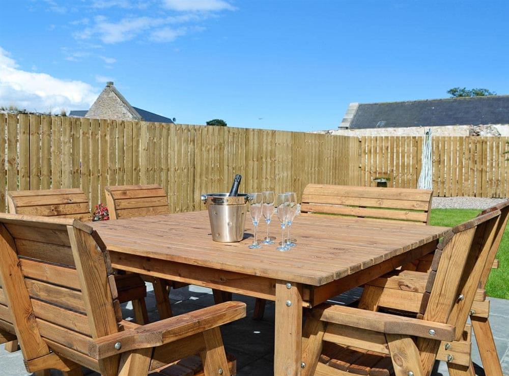 Peaceful garden with furniture, hot tub and BBQ at The Steading in Near Montrose, Angus