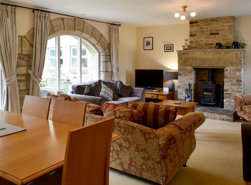 Relaxing lounge/dining room with multi-fuel stove (photo 2) at The Steadings in Alnwick, Northumberland