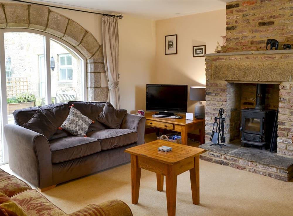 Relaxing lounge/dining room with multi-fuel stove at The Steadings in Alnwick, Northumberland