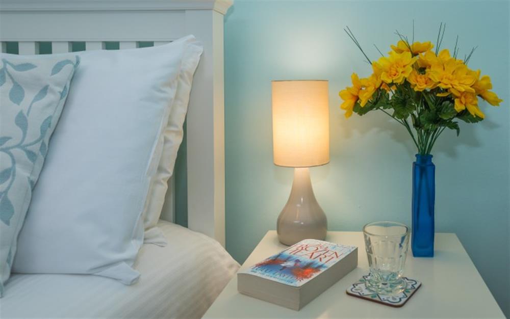 The lamp highlights the lovely shade of blue on the walls. at The Strand in Helford Passage