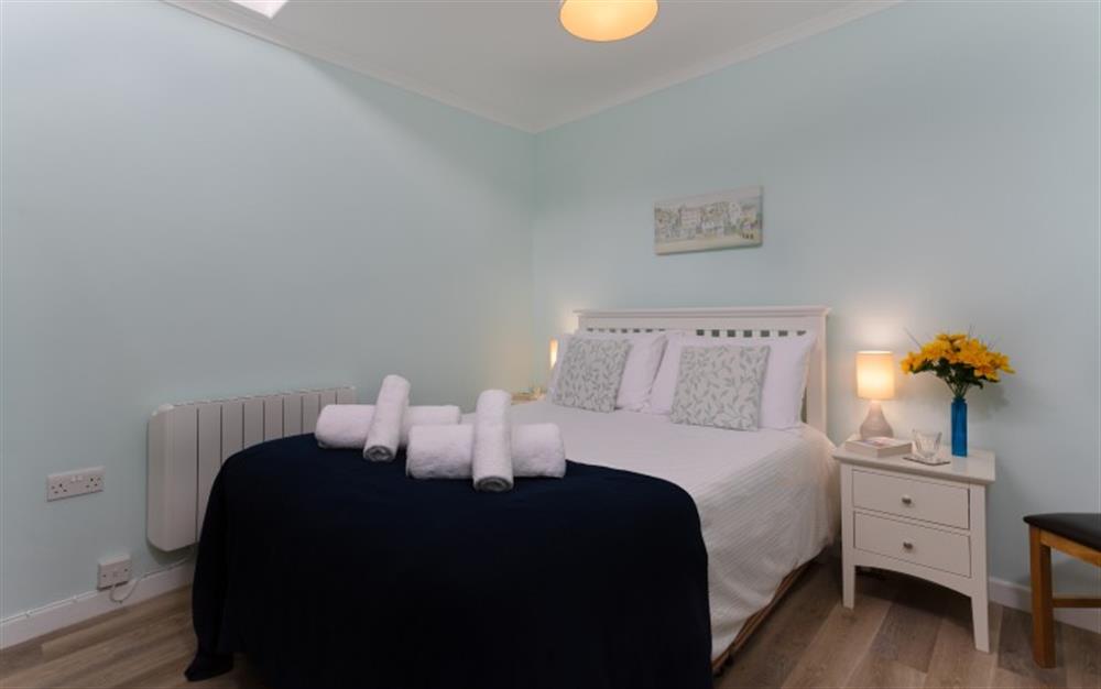 The master bedroom, decorated in a contemporary style, has a king-size bed. at The Strand in Helford Passage