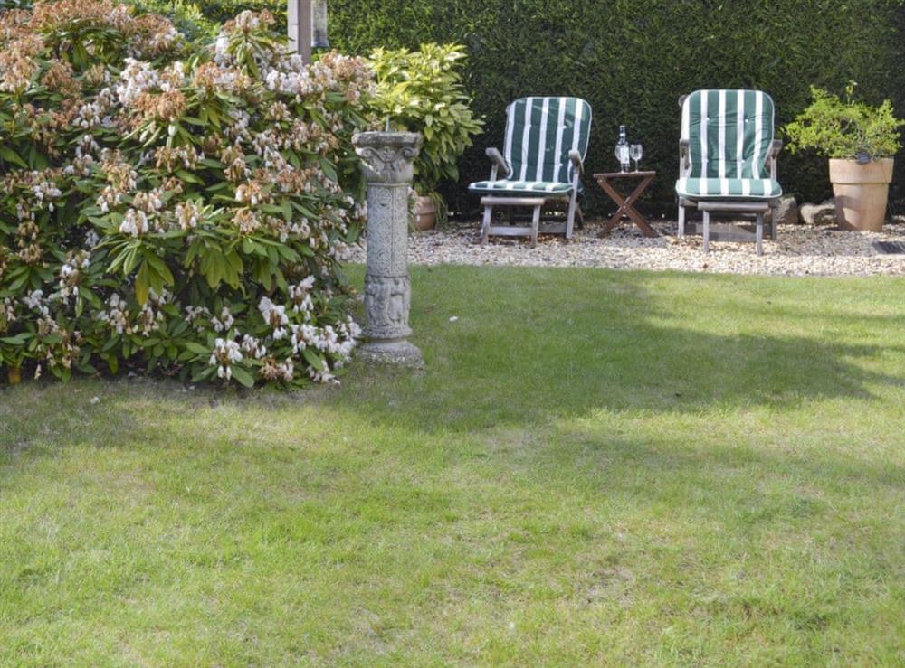 Lawned area of garden with additional seating at The Studio in Cuckfield, Sussex, West Sussex