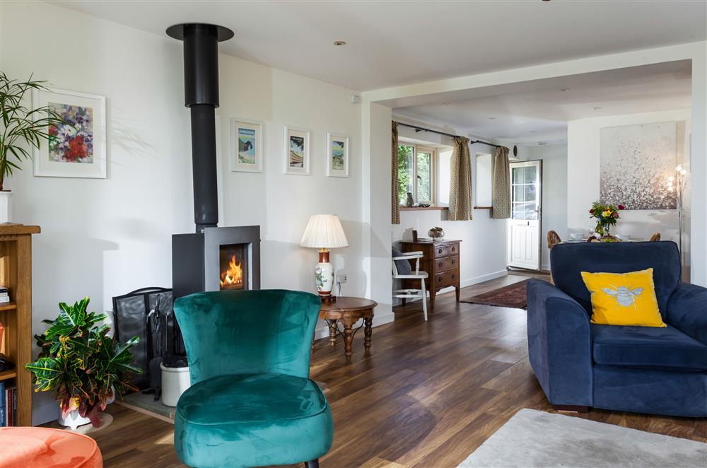 Relax on the sumptuous armchairs in front of the wood burning stove