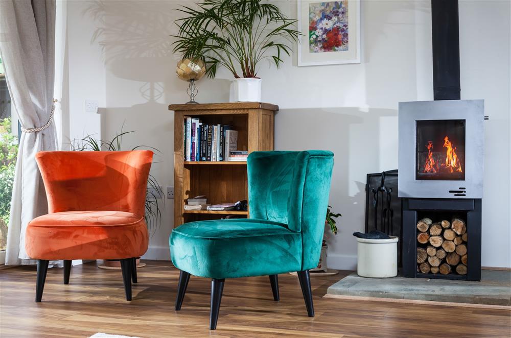 The bright and airy sitting area, with a beautiful wood burning stove