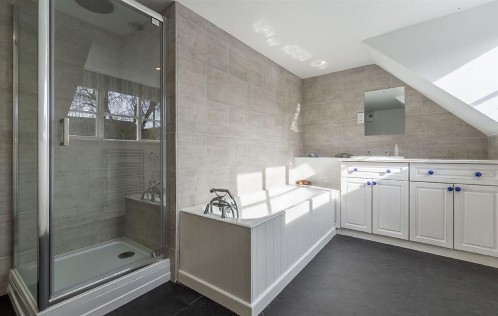 First floor: Master en-suite bathroom with bath and separate shower at The Tack House, Near Holkham