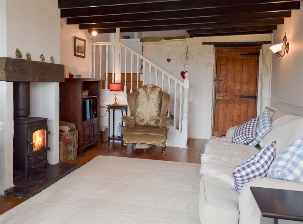 Living room with wood burner and patio doors leading to balcony at The Terrace in Rosebush, near Narberth, Dyfed