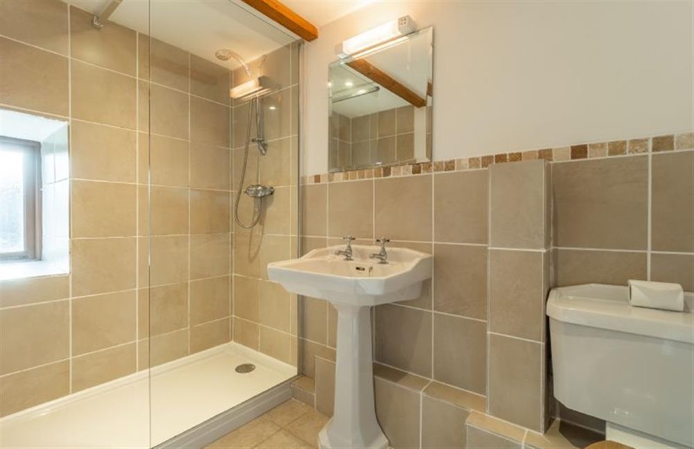 Bedroom one en-suite with large shower, wash basin and WC at The Threshing Barn, Cusgarne, Truro 